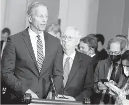  ?? MARIAM ZUHAIB/AP ?? Senate Minority Leader Mitch McConnell of Ky., second from left, listens as Sen. John Thune, R-S.D., speaks during a news conference on April 26 in Washington.