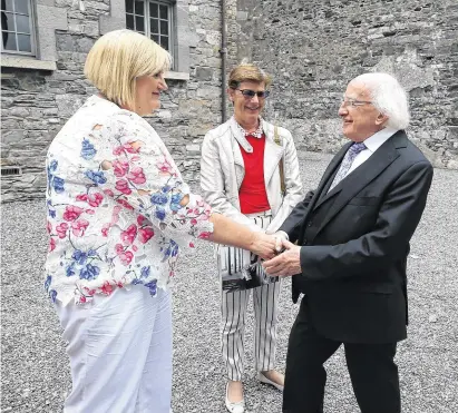  ??  ?? President Michael D Higgins meets Mary Manning and Karen Gearon, who were Dunnes Stores anti-Apartheid strikers, at the opening of the Nelson Mandela exhibition in Dublin on Thursday. Photo: Damien Eagers