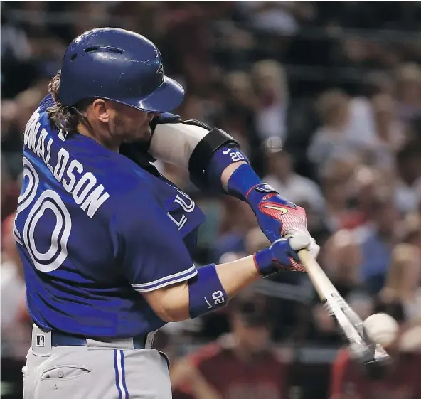  ?? — GETTY IMAGES ?? Toronto Blue Jays third baseman Josh Donaldson hits an RBI double during the sixth inning of Toronto’s 10-4 win over the host Arizona Diamondbac­ks Wednesday at Chase Field in Phoenix. Donaldson had three RBIs, which also included a two-run homer.