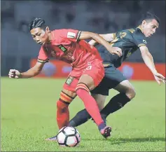  ??  ?? Sarawak’s Abdul Rahim Razak (left) tackling Terengganu’s Muhammad Ferris Danial during the FA Cup quarterfin­als at Stadium Negeri in Kuching. Sarawak lost 1-4 to the visitors in the April 21 match. — Bernama photo