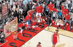 ?? MARK BLINCH THE CANADIAN PRESS FILE PHOTO ?? Kawhi Leonard, squatting in the middle, watches his game-winning buzzer beater win Game 7.