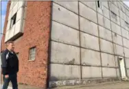  ?? RICHARD PAYERCHIN — THE MORNING JOURNAL ?? Jim Long, president of the Lorain Growth Corp.-Main Street Lorain, looks at the conditions around the building at 929 Broadway on Nov. 21, 2017. The Lorain County Land Reutilizat­ion Corp. will tear down the building soon.