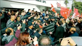  ??  ?? Angry protesters come face to face with police officers. Below, demonstrat­ors wave Turkish and TRNC flags.