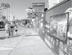  ?? DEWAYNE BEVIL/ORLANDO SENTINEL ?? Signs on a constructi­on wall indicate a new Universal Studios Store will open at Universal CityWalk, Universal Orlando confirmed on Friday.