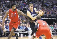  ?? LM Otero / Associated Press ?? The Mavericks’ Dirk Nowitzki (center) had a season-high 31 points, and DeAndre Jordan (left) got a season-worst greeting.