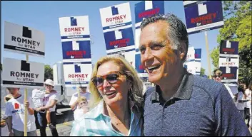  ?? Rick Bowmer The Associated Press ?? Mitt and Ann Romney walk Saturday in the Strawberry Day Parade in Pleasant Grove, Utah. Mitt Romney faces a GOP primary Tuesday for U.S. Senate.