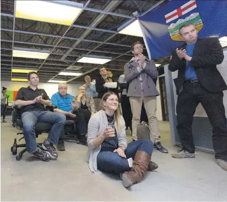  ?? ARYN TOOMBS/ CALGARY HERALD ?? Conservati­ve party supporters at Joan Crockatt’s campaign headquarte­rs in Calgary Centre applaud Monday during a televised speech by party leader Stephen Harper.