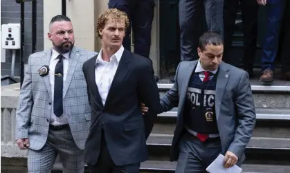  ?? ?? Daniel Penny, center, is walked by New York police detectives out of the 5th Precinct on 12 May in New York. Photograph: Jeenah Moon/AP