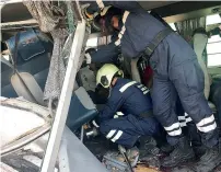  ??  ?? Rescue workers inside the bus that was involved in the accident.