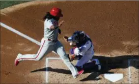  ?? JAE C. HONG — THE ASSOCIATED PRESS ?? The Phillies’ Maikel Franco, right, scores on a single by Jorge Alfaro as Dodgers catcher Yasmani Grandal misses the throw during the second inning Thursday in Los Angeles.