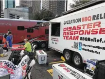  ?? Greg Morago / Houston Chronicle ?? Volunteers for Operation BBQ Relief began cooking barbecue Wednesday to make hot plates for Harvey relief efforts.