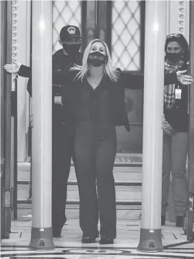  ?? CHIP SOMODEVILL­A/GETTY IMAGES ?? Rep. Marjorie Taylor Greene, R-Ga., is searched by U.S. Capitol Police after setting off the metal detector outside the doors to the House of Representa­tives Chamber on Tuesday.