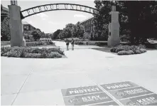  ?? FRAZIER/JOURNAL & COURIER] [NIKOS ?? “Protect Purdue” stickers are placed near the Gateway to the Future Arch at Purdue University on Aug. 7 in West Lafayette, Ind.