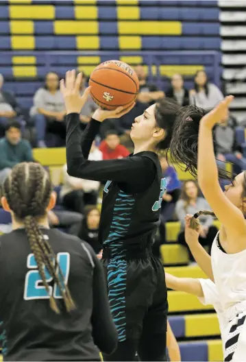  ?? LUKE E. MONTAVON/THE NEW MEXICAN ?? Capital High’s Ethena Silva makes a shot during Tuesday’s opening round of the District 5-5A Tournament in Toby Roybal Memorial Gymnasium. The Lady Jaguars won 53-44.