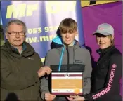 ??  ?? Myles Hewlett of United Striders receiving his Mr Oil athlete of the month award from Paddy Morgan (Athletics Wexford) and Marie Mooney from Mr Oil.
