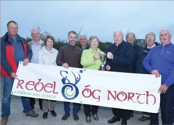  ??  ?? Teresa Carroll presents the Denis Carroll Memorial Cup to Seán McAuliffe, Chairman, Rebel Og North Cork in the presence of Board officers Peter Watson and Denis Guiney, Freemount GAA Con Twomey, Jim Guiney, Paddy Collins and family members Ben Carroll, Marjorie and Jim O’Regan. Picture John Tarrant