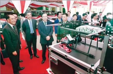  ?? HENG CHIVOAN ?? Chinese aid provided at a ceremony included four Jinbei minibuses, 10 motorbikes, 40 items of mine-detecting equipment, 110 boxes of materials for mine clearance and five drones.