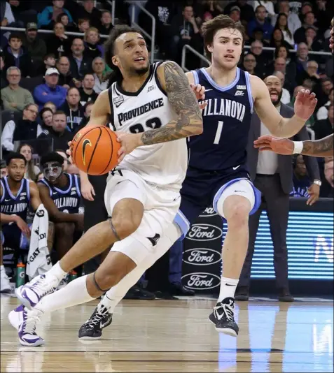  ?? File photo ?? Devin Carter, left, and the Providence Friars can cement a spot in the NCAA Tournament with a win over No. 2 UConn Saturday. Villanova can also make a claim for a spot by sweeping away Creighton.