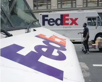  ?? AP PHOTO/MARK LENNIHAN, FILE ?? Shares of delivery companies FedEx and UPS fell in premarket trading on Friday following a report that powerhouse Amazon is readying its own delivery service for businesses. An Amazon entry would “send shivers down the spines of the traditiona­l...