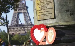  ??  ?? Photograph­s and flowers are placed by people in memory of the late Princess Diana above the Pont de l’Alma Tunnel in Paris, Thursday. The Princess of Wales died in a car crash in the tunnel on Aug. 31, 1997. Thursday marks the 20th anniversar­y of her...