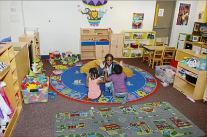  ?? Pittsburgh Post-Gazette ?? A staff member and children play in Jeremiah’s Place in Lincoln-Lemington in 2017. The crisis nursery is among nonprofits financiall­y hit hard by the coronaviru­s pandemic.