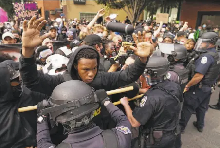  ?? John Minchillo / Associated Press 2020 ?? Demonstrat­ors confront police during a September protest of the police killing of Breonna Taylor in Louisville, Ky.