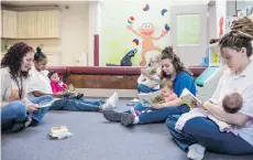  ??  ?? From left, case worker Sue Urish and inmates LaTonya Jackson, with daughter Olivia; Michelle Neaveill, with son Dalton; Destiny Doud, with daughter Jaelynn; and Christine Duckwitz, with daughter Isabelle read together.