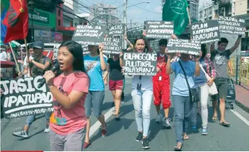  ?? AP FOTO/ BULLIT MARQUEZ ?? RALLY. Protesters display placards during a brief rally near the Malacañang to urge President Rodrigo Duterte to resume peace talks with communist rebels.