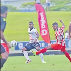  ?? Picture: JONA KONATACI ?? Suva’ Joeli Ranitu, left, applys the pressure as Labasa’s Ilisoni Lolaivalu clears the ball during the Digicel Premier League game at the ANZ Stadium yesterday.