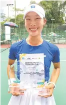  ?? ?? Hong Yeri poses with her trophies and certificat­e.