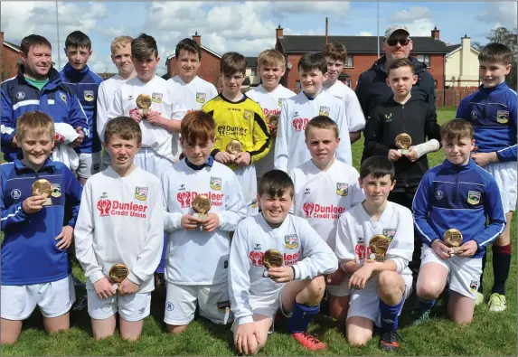  ??  ?? Dr omin United players with their runners-up trophies after going down to Bay United in the Dundalk Schoolboy League Under-13 Division 1 title play-off.