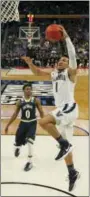  ?? BILL WIPPERT - AP ?? Villanova guard Jalen Brunson (1) drives to the basket against Mount St. Mary’s guard Junior Robinson (0) during the first half of a first-round men’s college basketball game in the NCAA Tournament, Thursday, in Buffalo, N.Y.