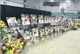  ?? PHOTOS: JONATHAN HAYWARD — THE ASSOCIATED PRESS ?? Photos of the 15 killed in Friday’s bus crash are displayed at Sunday’s vigil at the Elgar Petersen Arena in Humboldt, Canada. Prime Minister Justin Trudeau attended the vigil.