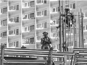  ?? The STAR / Ernie Penaredond­o ?? Workers are seen performing their duties at a constructi site in Taguig on February 7, 2024.