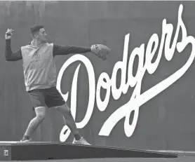  ?? JOE CAMPOREALE/USA TODAY SPORTS ?? Dodgers pitcher Bobby Miller stretches during a workout at Camelback Ranch in Arizona.