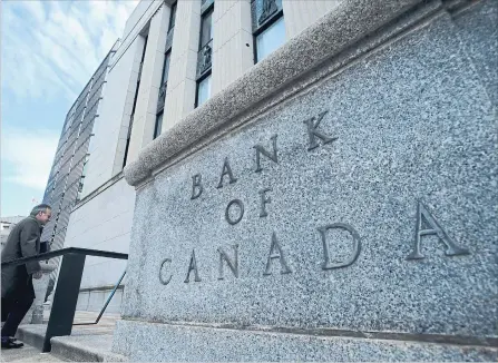  ?? SEAN KILPATRICK THE CANADIAN PRESS ?? Bank of Canada governor Stephen Poloz returns to his bank after a news conference in Ottawa. The bank is on a rate-hiking path to prevent inflation from climbing too high.