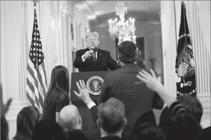  ?? DOUG MILLS /THE NEW YORK TIMES ?? President Donald Trump engages in a heated exchange with CNN reporter Jim Acosta at a White House news conference Wednesday. CNN sued the Trump administra­tion Tuesday in an effort to reinstate the press credential­s of Acosta, escalating a dispute that has highlighte­d the increasing­ly tense dynamic between Trump and the news media.