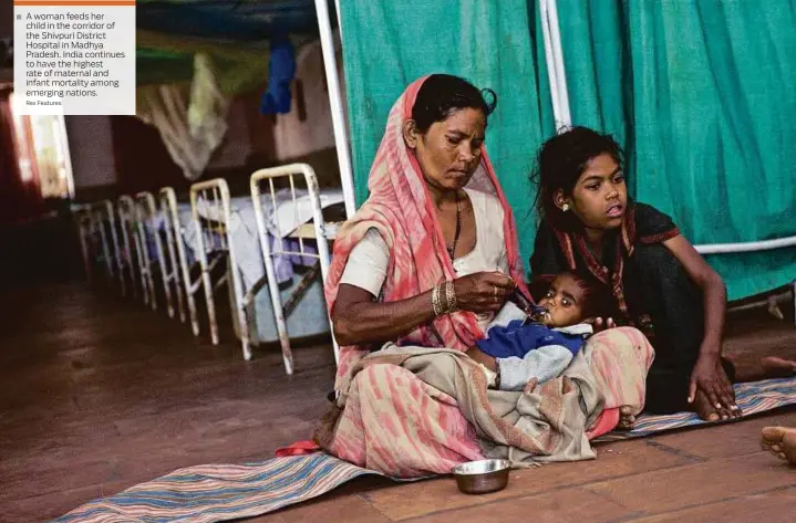  ?? Rex Features ?? A woman feeds her child in the corridor of the Shivpuri District Hospital in Madhya Pradesh. India continues to have the highest rate of maternal and infant mortality among emerging nations.