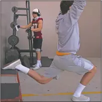  ??  ?? El Modena tight end Owen Mull hangs his mask on a weight bar while working out at a school gym temporaril­y set up at outdoor racquetbal­l courts before the game.