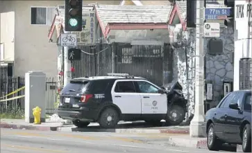  ?? Christian K. Lee Los Angeles Times ?? A POLICE CAR crashed near the intersecti­on of 77th and San Pedro streets in Los Angeles on June 15, after several teens in the LAPD’s cadet program stole police cruisers and led officers on chases, authoritie­s said.