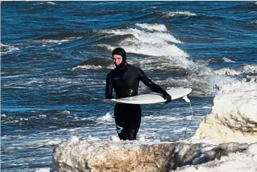  ?? — AFP ?? Surfing in winter is an actual sport. At least in Russia.