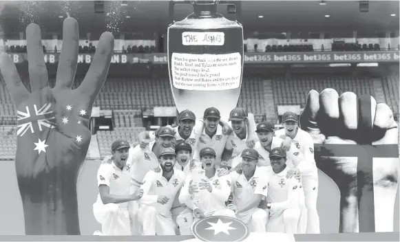  ??  ?? Australia’s captain Steve Smith holds the Ashes trophy next to team mates after they won the fifth Ashes cricket test match and the series 4-0. REUTERS/David Gray