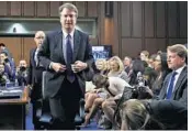  ?? JACQUELYN MARTIN/AP ?? President Donald Trump's Supreme Court nominee, Brett Kavanaugh, leaves for a lunch break while appearing before the Senate Judiciary Committee on Capitol Hill in Washington on Tuesday. Kavanaugh said he would be “nonpartisa­n” as a Supreme Court justice.