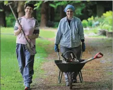  ??  ?? Kate and Sr Denise returning from a morning’s gardening laden with their tools.