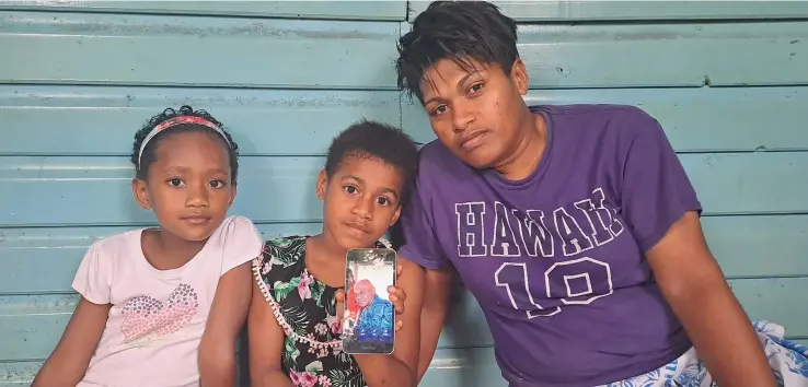  ?? Photo: Waisea Nasokia ?? Maloni Nadoi’s adopted daughter Kristina Tutugalala (right) with Mr Nadoi’s granddaugh­ters Litiana Rawei, Losena Narogo at their residence at Sabeto Village, Nadi as they show a photo of the late Mr Nadoi.