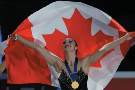  ?? AP PHOTO ?? Kaetlyn Osmond celebrates after winning the women’s free skating program at the Figure Skating World Championsh­ips in Assago, Italy on Friday.