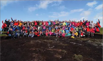  ??  ?? Summit celebratio­ns! Mountain climbers rejoice at reaching the top in fine weather.