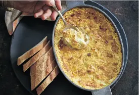  ?? STEVE GIRALT ?? This comforting baked goat cheese, fava and artichoke dip can be made ahead of time and popped in the oven at the last minute.