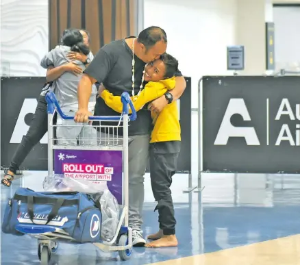  ??  ?? Travellers from Cook Islands greeted by loved ones at Auckland Airport in New Zealand on January 22, 2021.