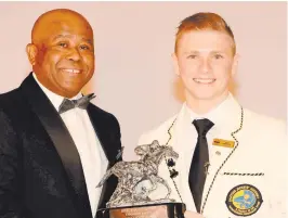  ?? Picture: JC Photograph­ic ?? YOUNG GUN: Champion Jockey Lyle Hewitson collects his trophy from National Horseracin­g Authority CEO Lyndon Barends at the Equus Awards ceremony this week. The first apprentice rider to win the championsh­ip in more than 40 years, Hewitson is recovering from an injury but hopes to be back in the saddle by September 20 – just in time to take part in the Internatio­nal Jockey Challenge to be held in Singapore on September 25, where he’ll compete against stars like Joao Moreira, Hugh Bowman and Hayley Turner.